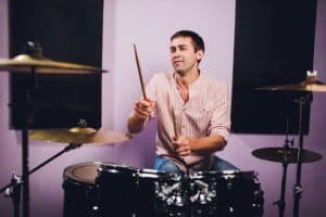 man playing a drum in a recording studio